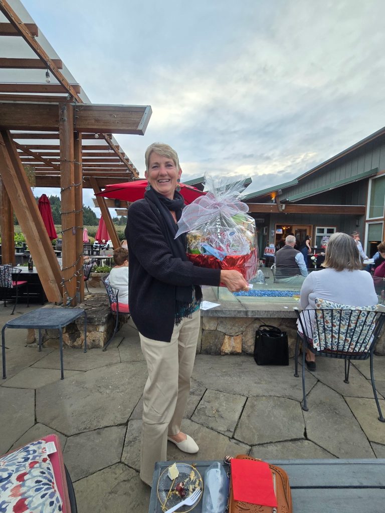 Attendee holding a gift basket at an outdoor gathering
