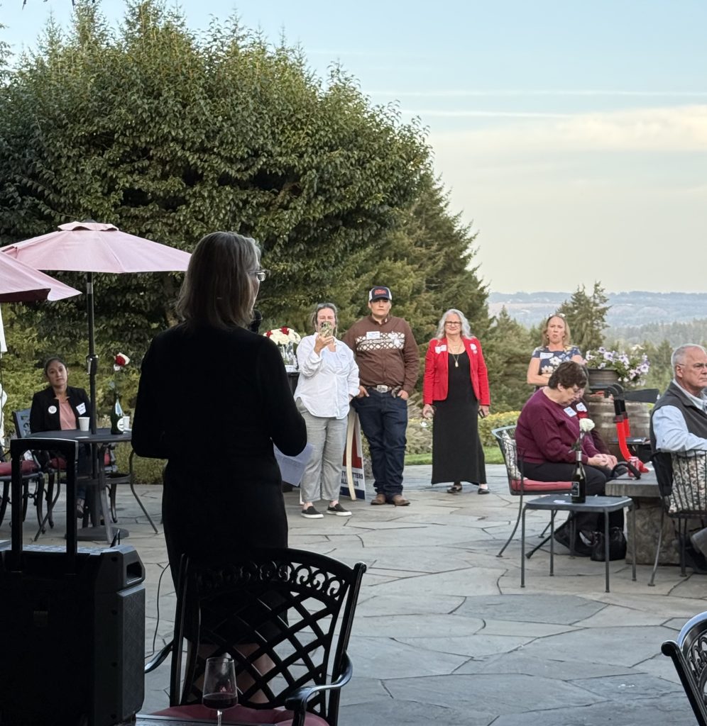 A speaker addressing guests on an outdoor patio